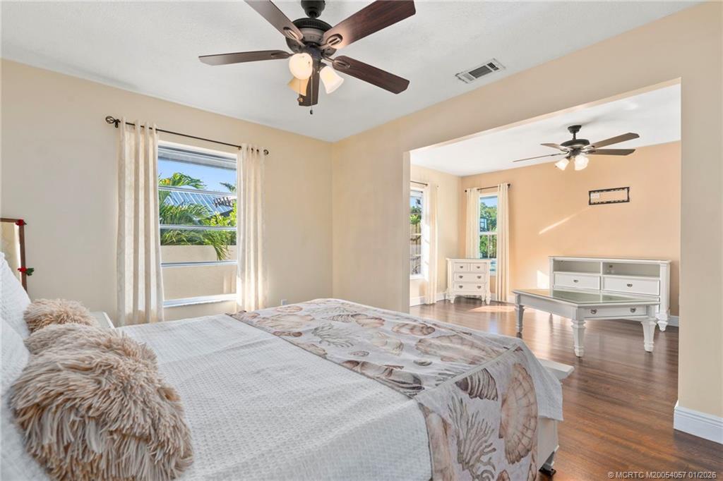 4599 Southeast Halston Court Stuart, FL 34997 - Photo 33 of 65 a bed sitting in a spacious bedroom next to a window