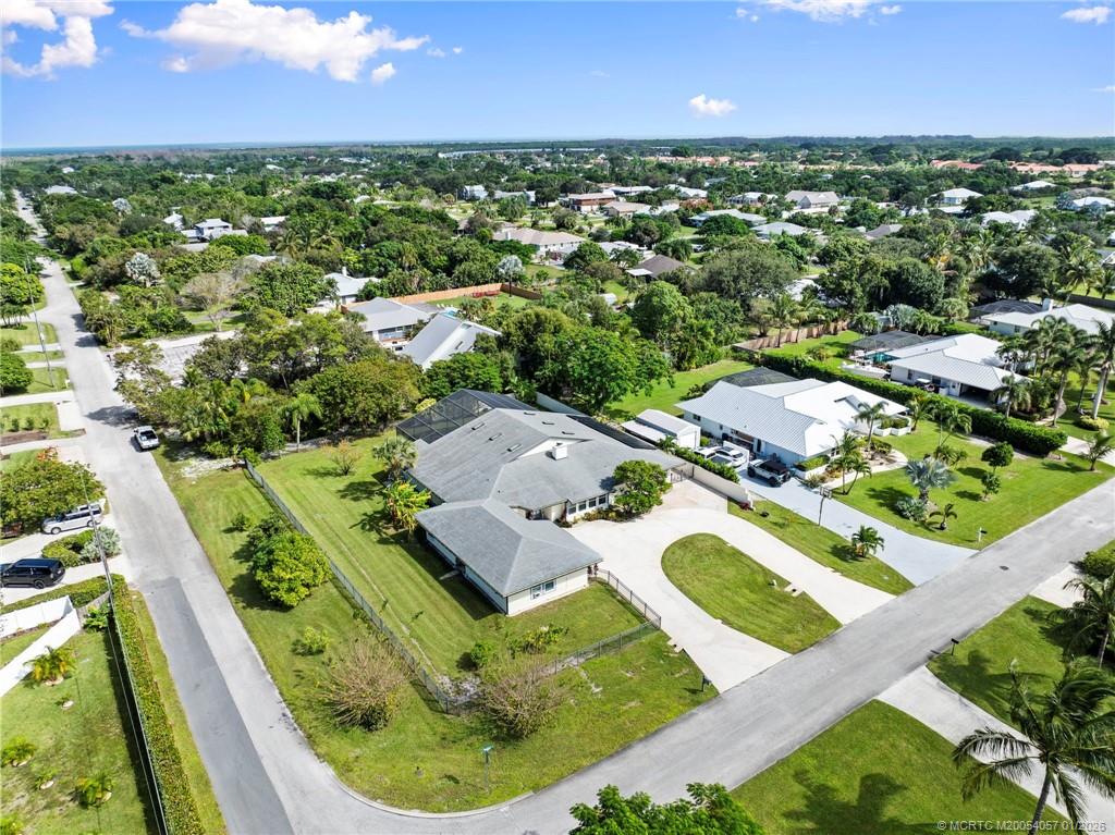 4599 Southeast Halston Court Stuart, FL 34997 - Photo 58 of 65 an aerial view of residential houses with outdoor space and trees