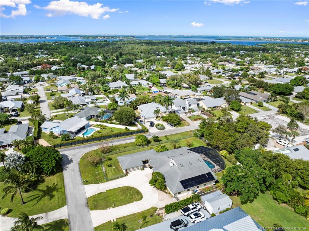4599 Southeast Halston Court Stuart, FL 34997 - Photo 62 of 65 an aerial view of residential houses with outdoor space and trees