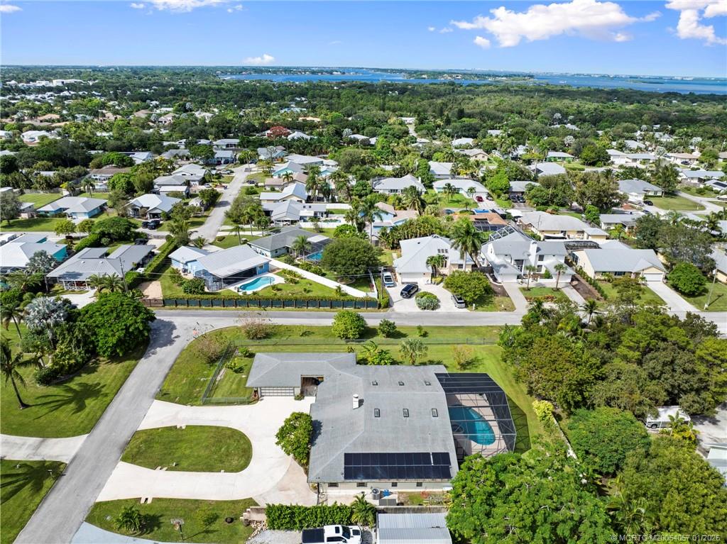 4599 Southeast Halston Court Stuart, FL 34997 - Photo 63 of 65 an aerial view of residential houses with outdoor space and trees