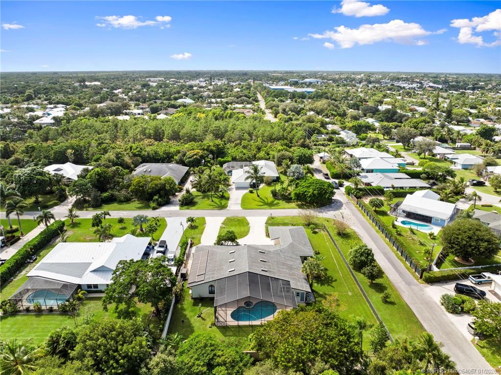 4599 Southeast Halston Court Stuart, FL 34997 - Photo 64 of 65 an aerial view of residential houses with outdoor space and trees