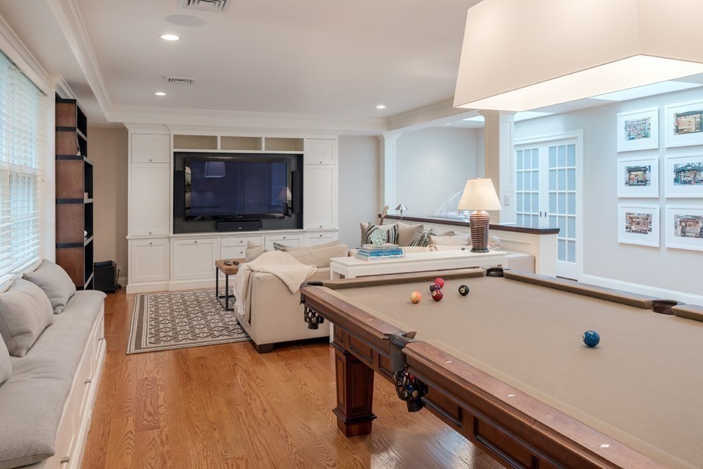 29 Whiting Road Wellesley, MA 02481 - Photo 28 of 36 a living room with a table chairs and a flat screen tv
