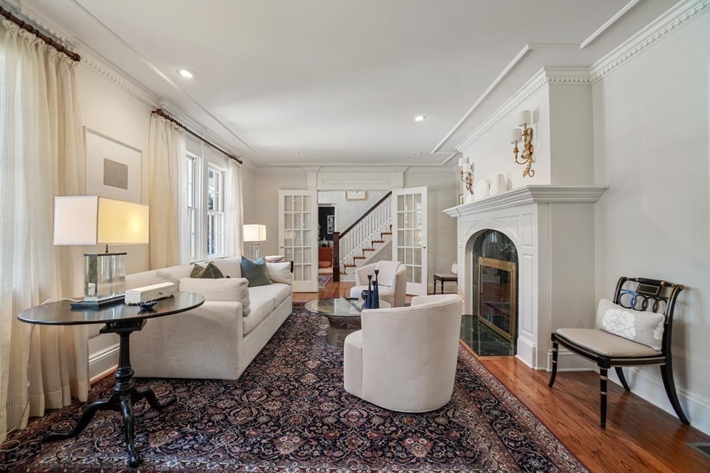 29 Whiting Road Wellesley, MA 02481 - Photo 3 of 36 a living room with furniture a fireplace and a table
