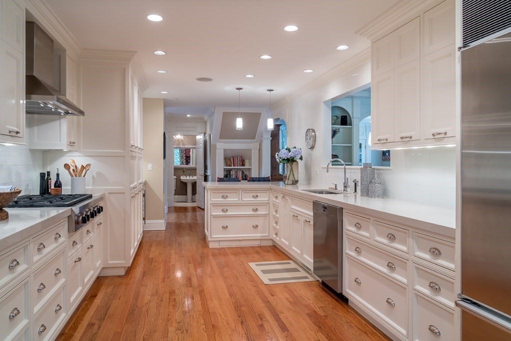 29 Whiting Road Wellesley, MA 02481 - Photo 7 of 36 a large kitchen with stainless steel appliances a large counter top a stove and a sink