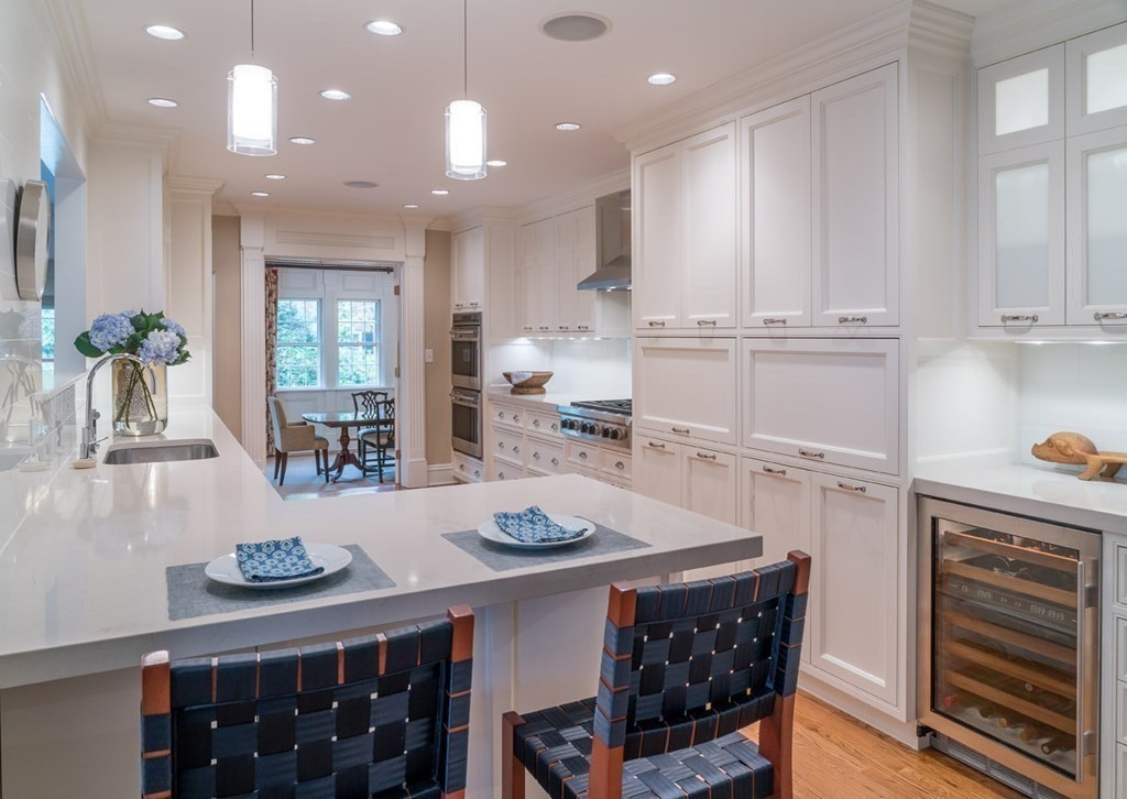 29 Whiting Road Wellesley, MA 02481 - Photo 8 of 36 a kitchen with granite countertop a table chairs stove and cabinets