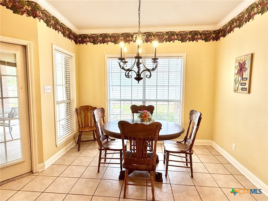 415 South Trinity Street Edna, TX 77957 - Photo 20 of 46 a view of a dining room with furniture and chandelier