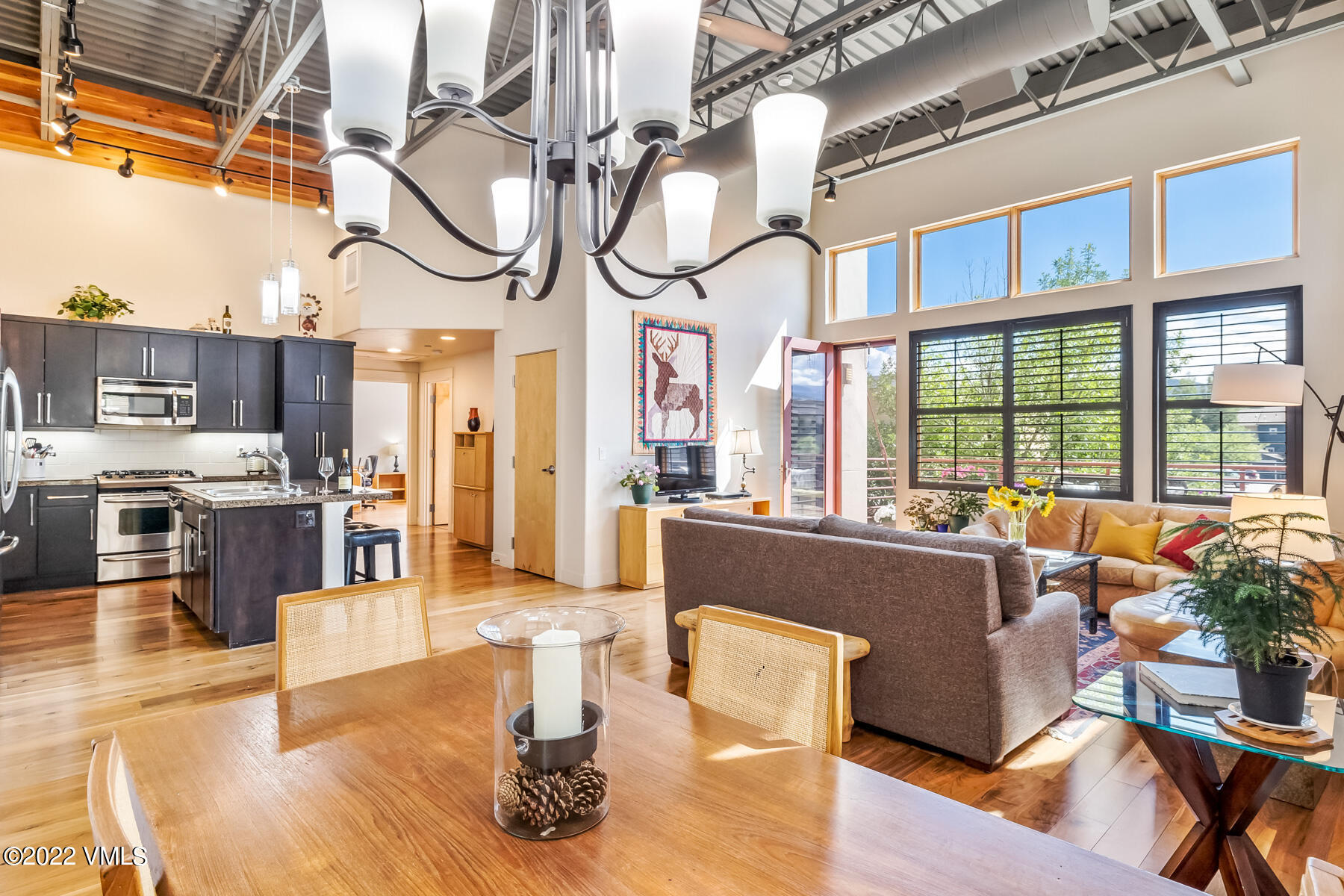 a living room with lots of furniture and a chandelier