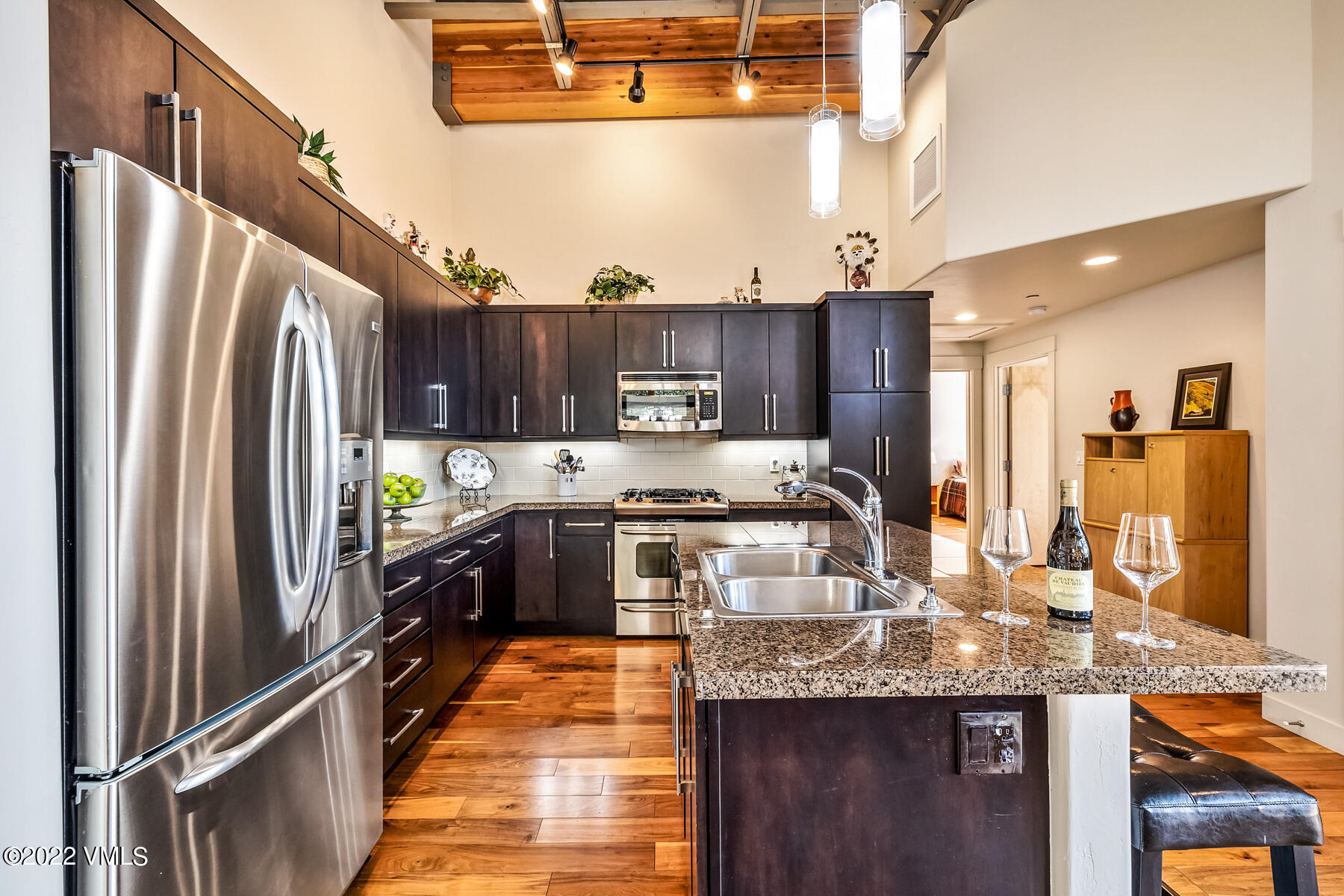1185 Capitol Street, Unit 203 Eagle, CO 81631 - Photo 11 of 22 a kitchen with granite countertop stainless steel appliances and wooden cabinets