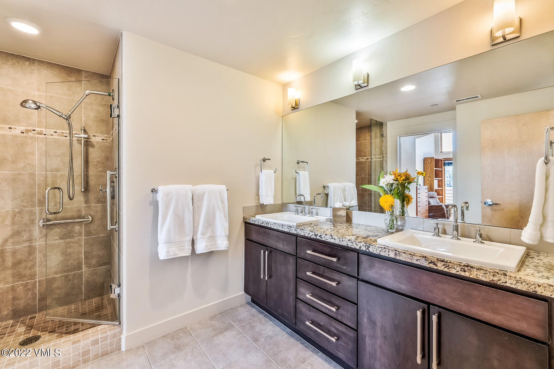 1185 Capitol Street, Unit 203 Eagle, CO 81631 - Photo 18 of 22 a bathroom with a granite countertop double vanity sink mirror and shower