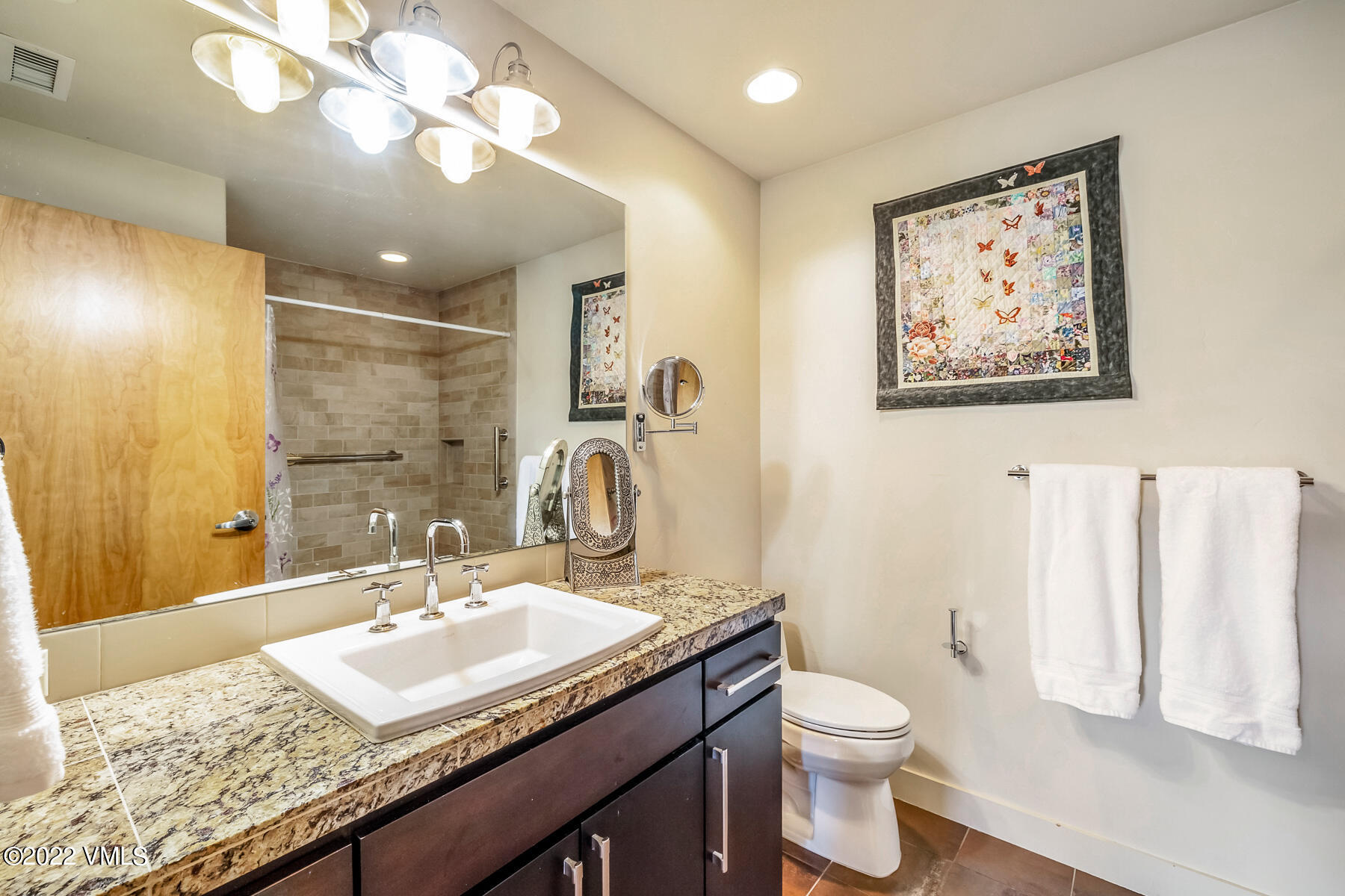 1185 Capitol Street, Unit 203 Eagle, CO 81631 - Photo 19 of 22 a bathroom with a granite countertop sink a toilet and a mirror