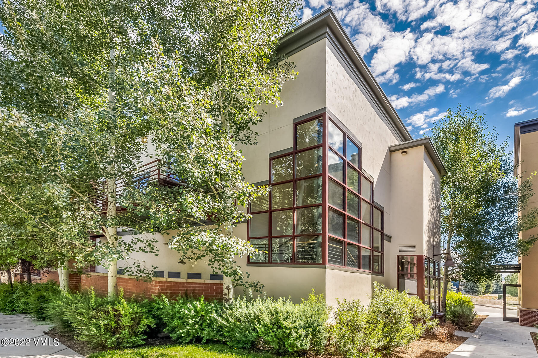 1185 Capitol Street, Unit 203 Eagle, CO 81631 - Photo 6 of 22 a view of a large white building next to a yard