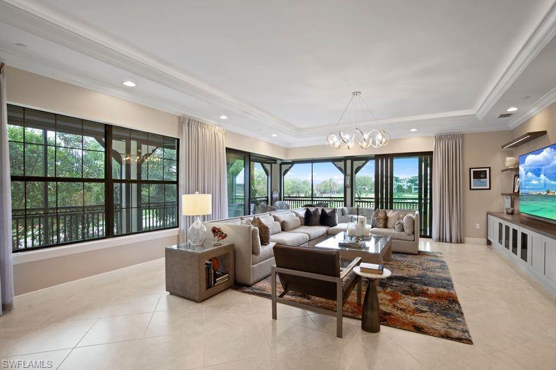 a living room with furniture large windows and a flat screen tv