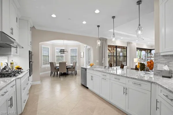 a kitchen with stainless steel appliances granite countertop a sink stove and cabinets