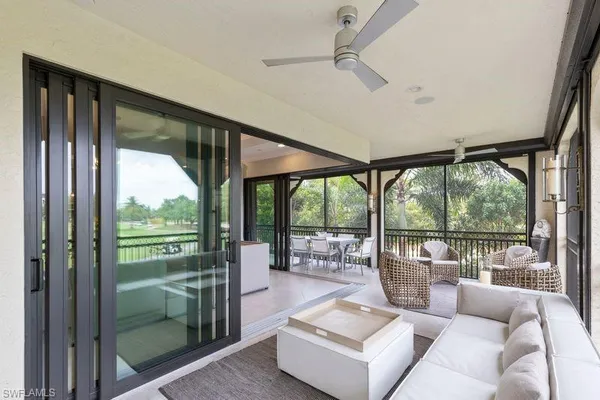 a living room with furniture and a floor to ceiling window
