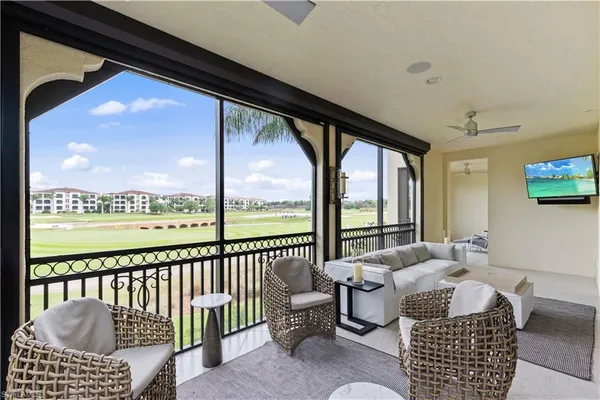 a view of a balcony with furniture and a floor to ceiling window