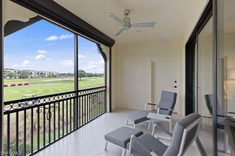 16391 Viansa Way, Unit 101 Naples, FL 34110 - Photo 20 of 49 a view of a balcony with furniture and a floor to ceiling window