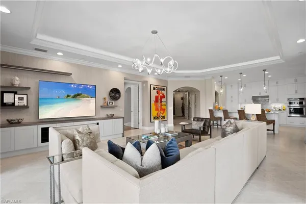 a living room with furniture and a chandelier
