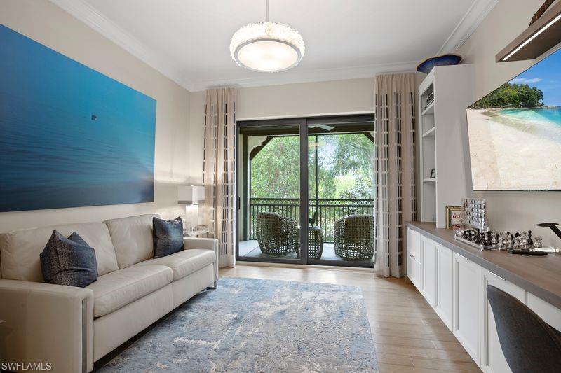 16391 Viansa Way, Unit 101 Naples, FL 34110 - Photo 21 of 49 a living room with furniture and a large window