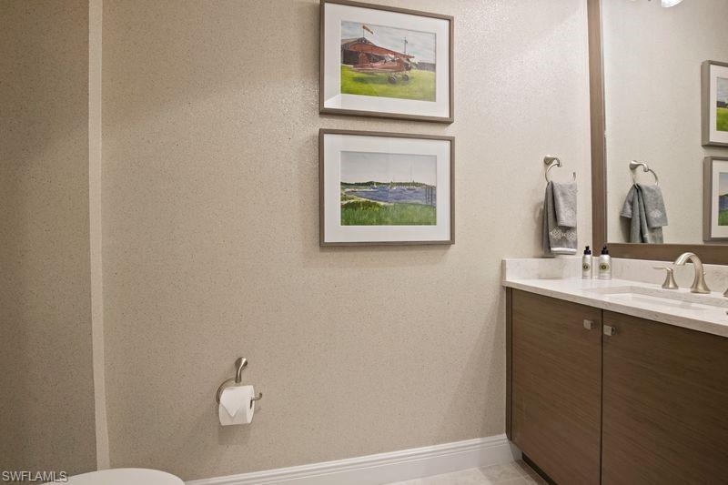 16391 Viansa Way, Unit 101 Naples, FL 34110 - Photo 22 of 49 a bathroom with a sink and a mirror