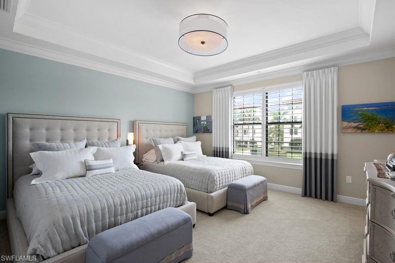 16391 Viansa Way, Unit 101 Naples, FL 34110 - Photo 28 of 49 a bedroom with two beds and ceiling fan