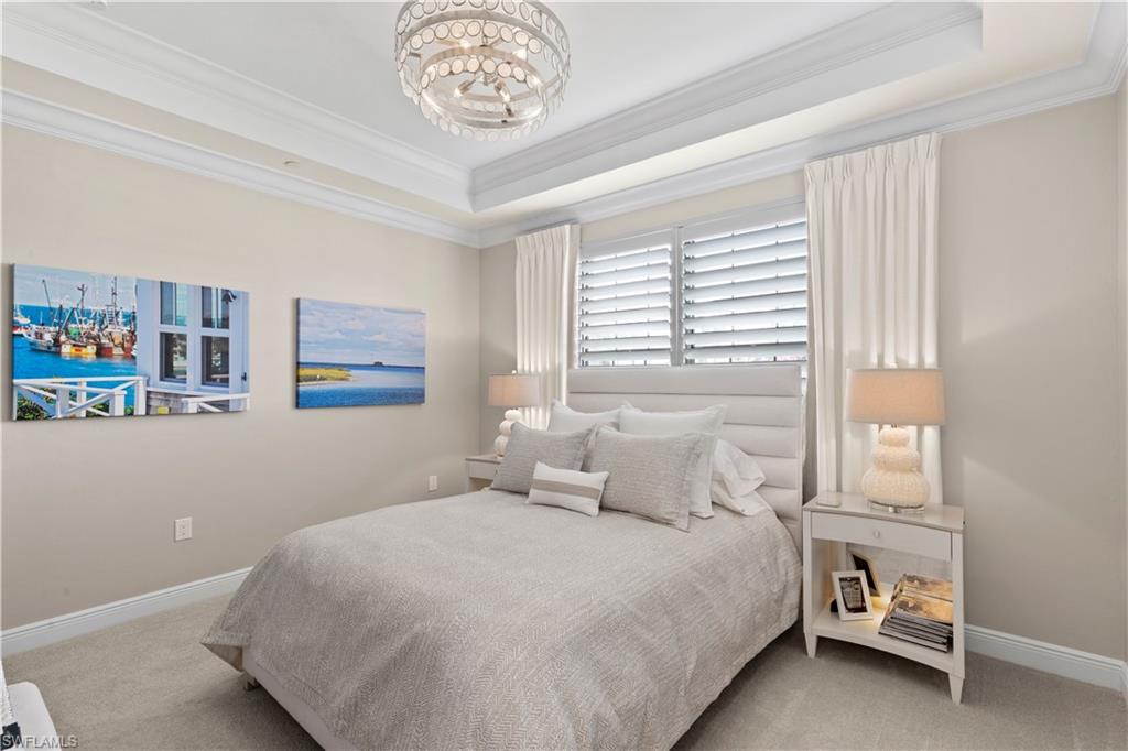 16391 Viansa Way, Unit 101 Naples, FL 34110 - Photo 31 of 49 a bedroom with a bed and a window