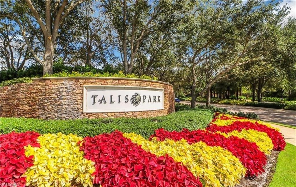 16391 Viansa Way, Unit 101 Naples, FL 34110 - Photo 35 of 49 a view of a sign board with flower around