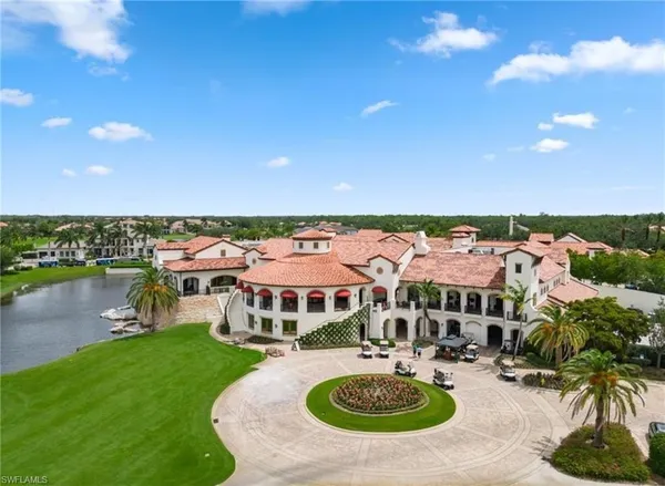 an aerial view of house with yard swimming pool and ocean view