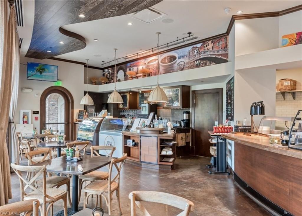 16391 Viansa Way, Unit 101 Naples, FL 34110 - Photo 43 of 49 a group of people sitting in a living room