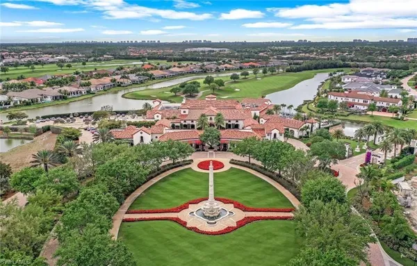 an aerial view of a golf course with a lake view