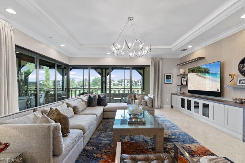 16391 Viansa Way, Unit 101 Naples, FL 34110 - Photo 6 of 49 a living room with furniture and a flat screen tv