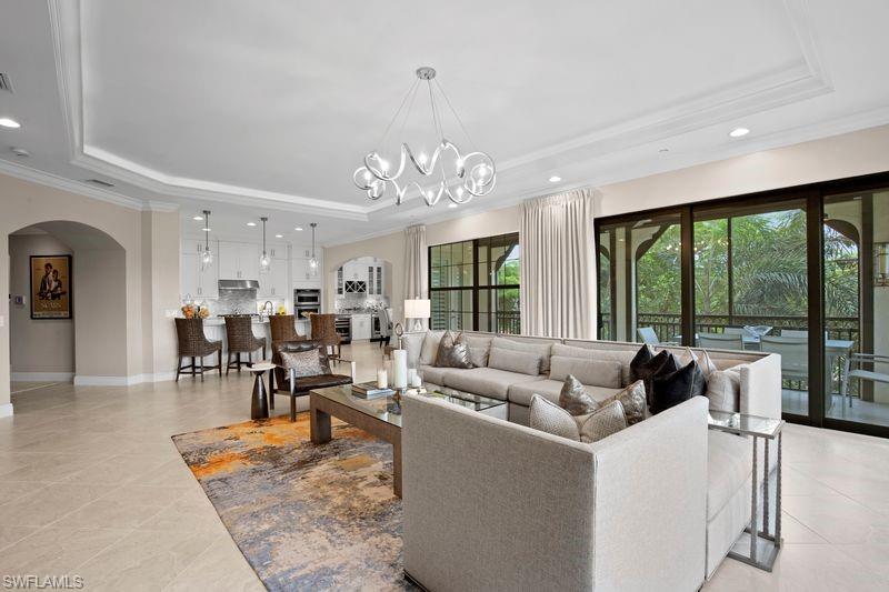 16391 Viansa Way, Unit 101 Naples, FL 34110 - Photo 7 of 49 a living room with furniture and a large window
