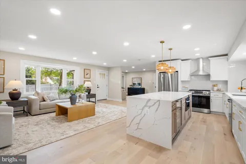 a large living room with stainless steel appliances kitchen island granite countertop a large kitchen counter top stainless steel appliances and couches