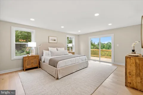 a spacious bedroom with a large bed and a large window