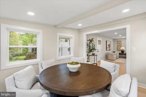 a living room with furniture a window and a dining table with garden view