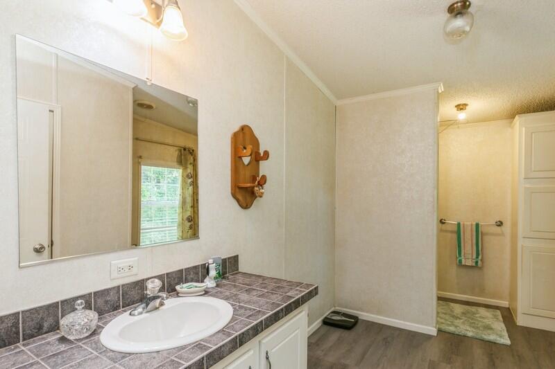 3928 Chambray Road Crestview, FL 32539 - Photo 23 of 35 a bathroom with a granite countertop sink and a mirror