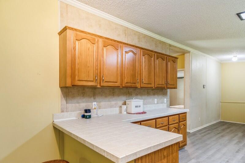 3928 Chambray Road Crestview, FL 32539 - Photo 7 of 35 a kitchen with stainless steel appliances a sink a stove and a refrigerator