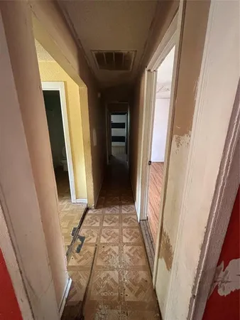 a view of a hallway with wooden floor and stairs