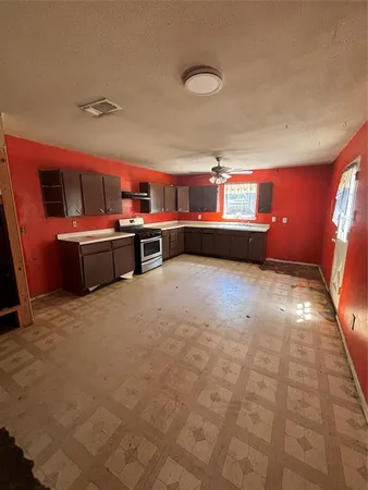 a kitchen with a stove and a refrigerator