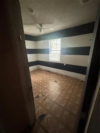 a view of an empty room and a window