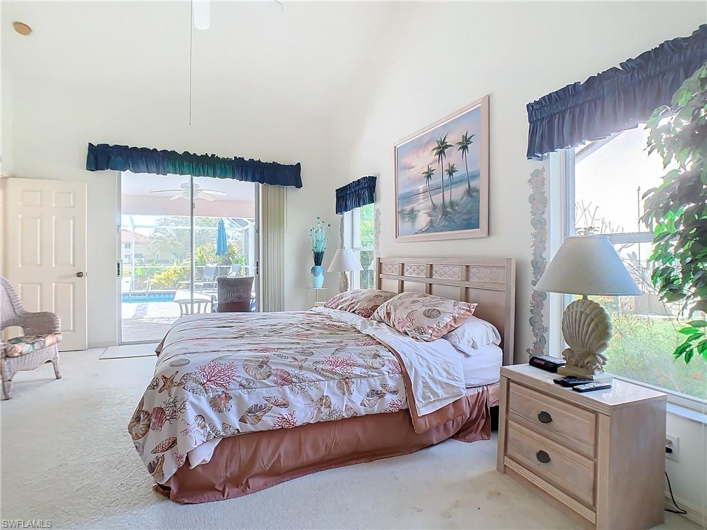 147 Plantation Circle Naples, FL 34104 - Photo 15 of 32 a bedroom with a large bed and a window
