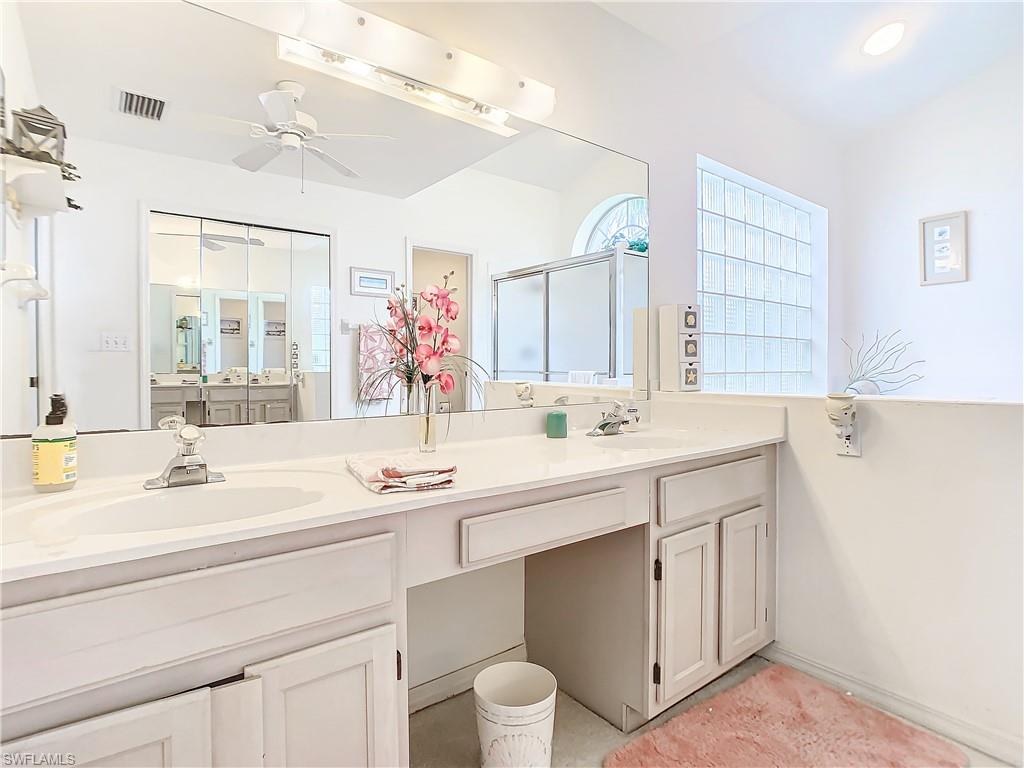 147 Plantation Circle Naples, FL 34104 - Photo 16 of 32 a bathroom with a sink double vanity and a mirror