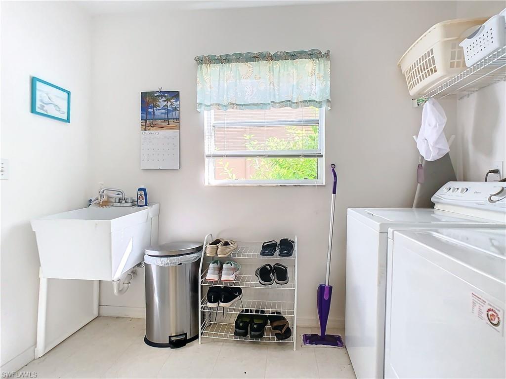 147 Plantation Circle Naples, FL 34104 - Photo 21 of 32 a bathroom with a sink a toilet and a window