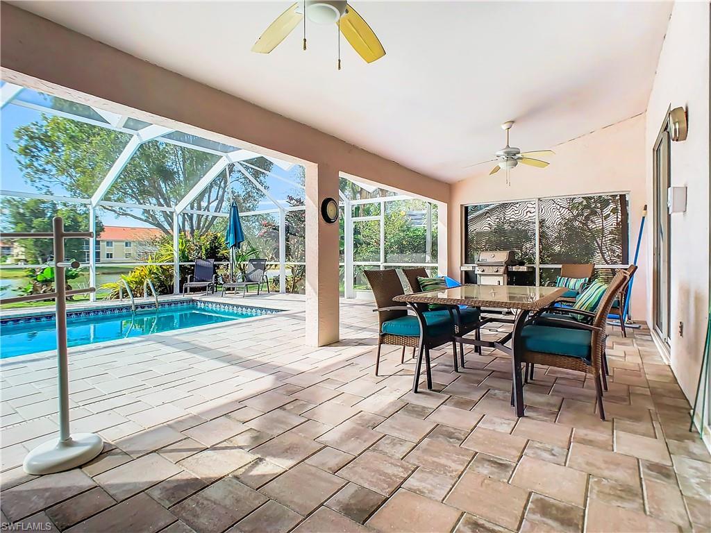 147 Plantation Circle Naples, FL 34104 - Photo 22 of 32 a view of a patio with table and chairs floor to ceiling window with wooden floor