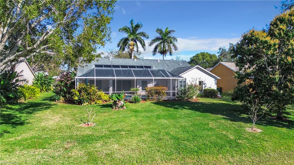 147 Plantation Circle Naples, FL 34104 - Photo 25 of 32 a view of a house with backyard and sitting area