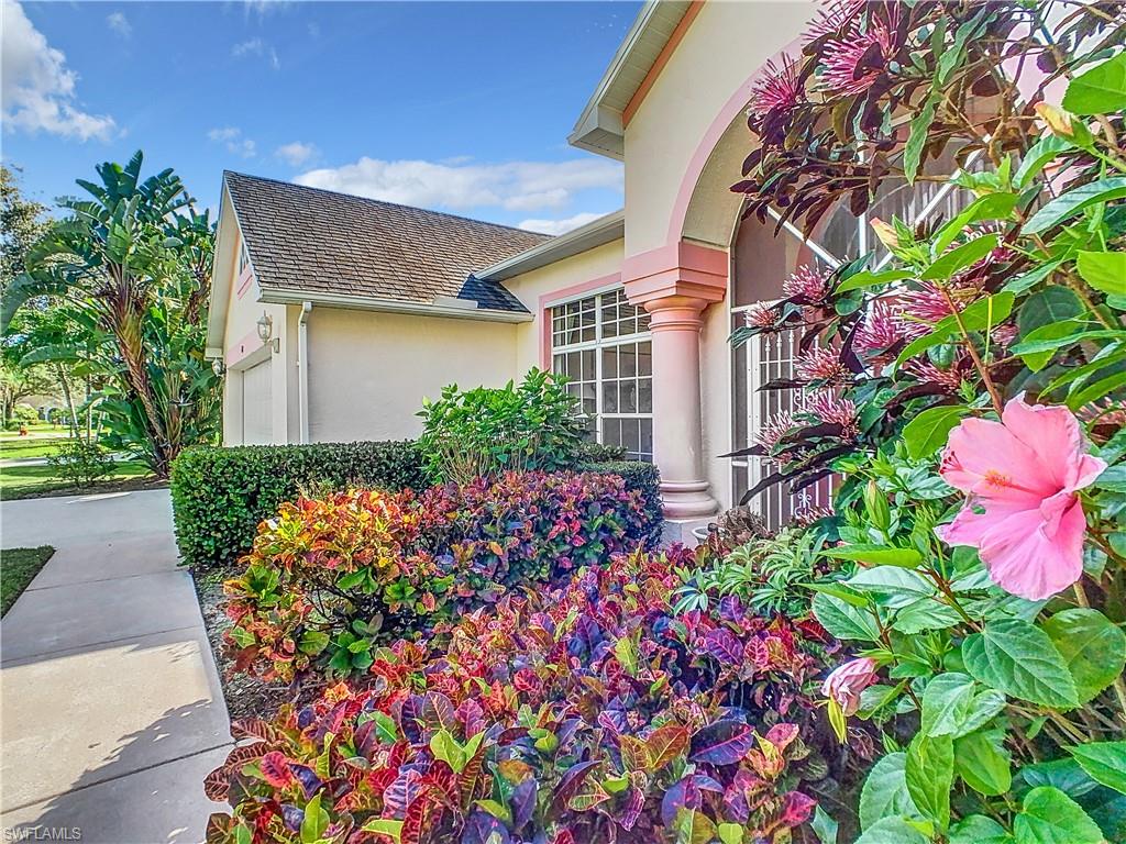 147 Plantation Circle Naples, FL 34104 - Photo 32 of 32 a front view of a house with lots of flower and flowers
