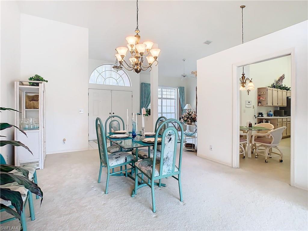147 Plantation Circle Naples, FL 34104 - Photo 7 of 32 a view of a dining room with furniture and a chandelier