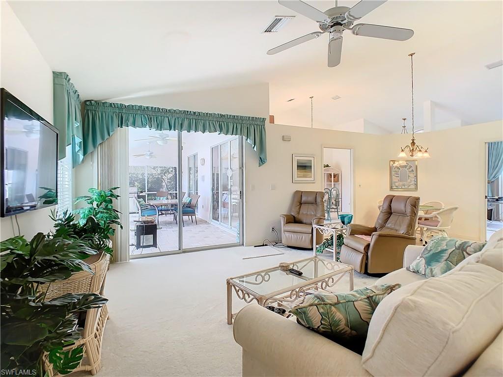 147 Plantation Circle Naples, FL 34104 - Photo 9 of 32 a living room with furniture and a large window