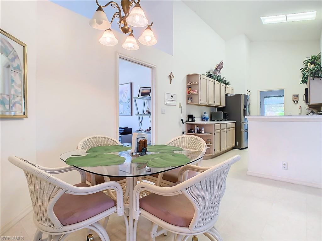 147 Plantation Circle Naples, FL 34104 - Photo 10 of 32 a dining room with furniture and wooden floor