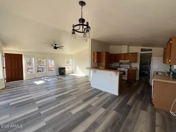 a view of living room with furniture and wooden floor
