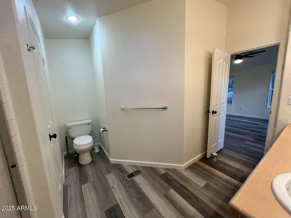 a bathroom with a granite countertop toilet and a shower